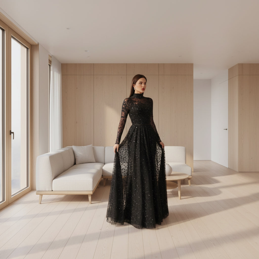 Woman wearing a black sequin dress with sheer sleeves in an indoor setting.