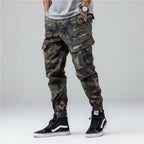 Front view of men’s camo harem jogger pants featuring slim tapered ankle streetwear design