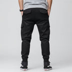 Front view of men’s camo harem jogger pants featuring slim tapered ankle streetwear design