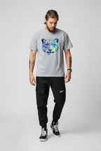 Front view of men’s camo harem jogger pants featuring slim tapered ankle streetwear design