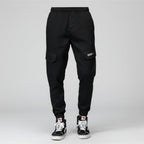 Front view of men’s camo harem jogger pants featuring slim tapered ankle streetwear design
