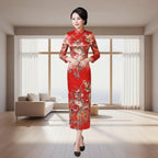 Woman in a red floral dress standing in a room with wicker stools and a wooden table.