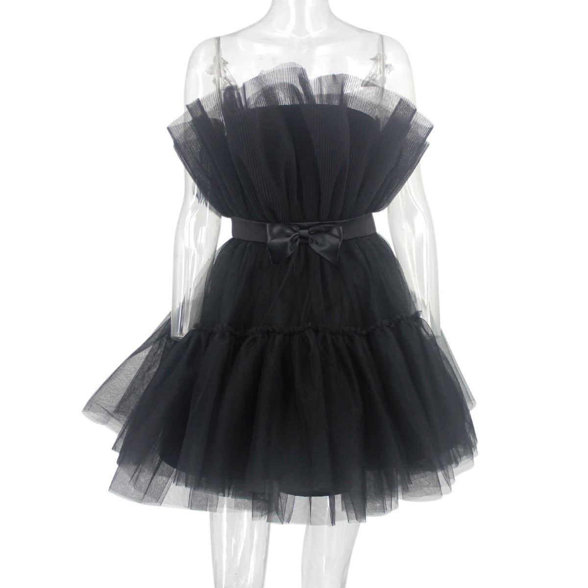 Black tulle dress on a mannequin against a white background